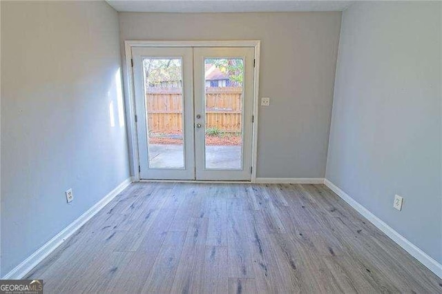 entryway featuring light hardwood / wood-style floors and french doors