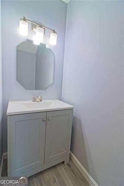 bathroom with wood-type flooring and vanity