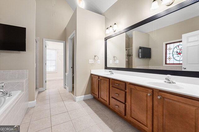 bathroom featuring tile patterned flooring, shower with separate bathtub, and vanity