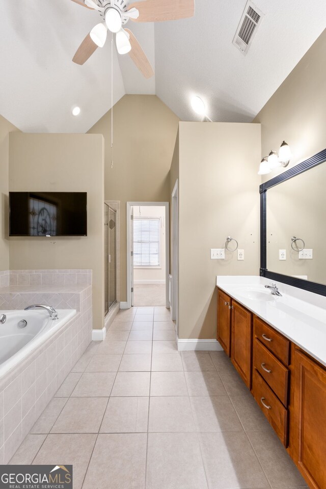 bathroom featuring vanity, lofted ceiling, plus walk in shower, tile patterned flooring, and ceiling fan