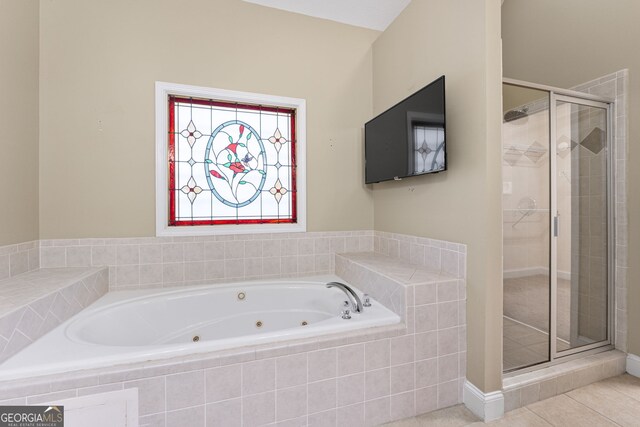 bathroom with shower with separate bathtub and tile patterned floors