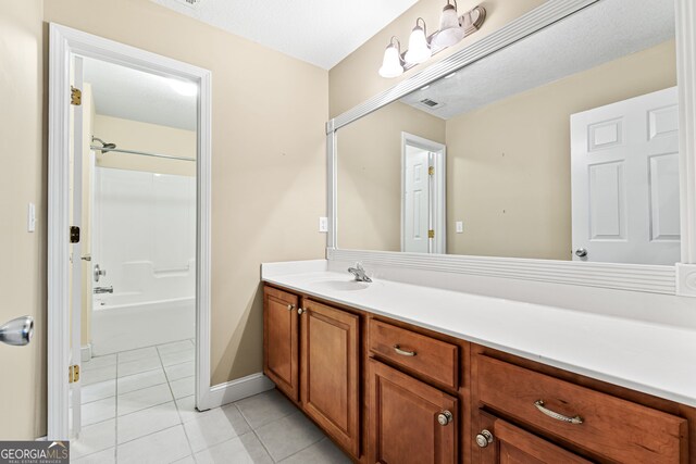 bathroom featuring bathtub / shower combination, a textured ceiling, vanity, and tile patterned floors