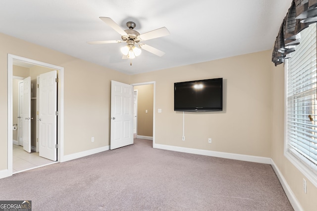 unfurnished bedroom with light colored carpet and ceiling fan