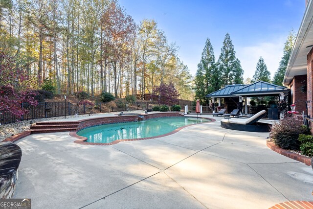 view of swimming pool featuring a gazebo and a patio area