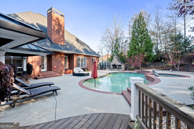 view of swimming pool with an in ground hot tub and a patio