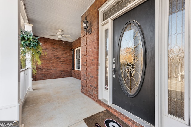 doorway to property with ceiling fan and covered porch