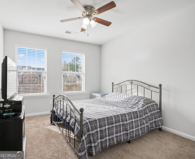 bedroom featuring carpet flooring, ceiling fan, visible vents, and baseboards