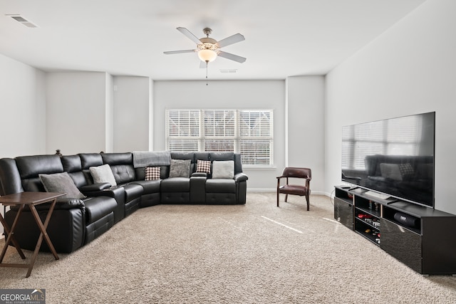 carpeted living room featuring a wealth of natural light and ceiling fan