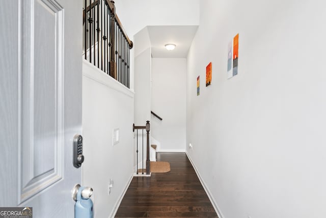 hall with dark wood-type flooring