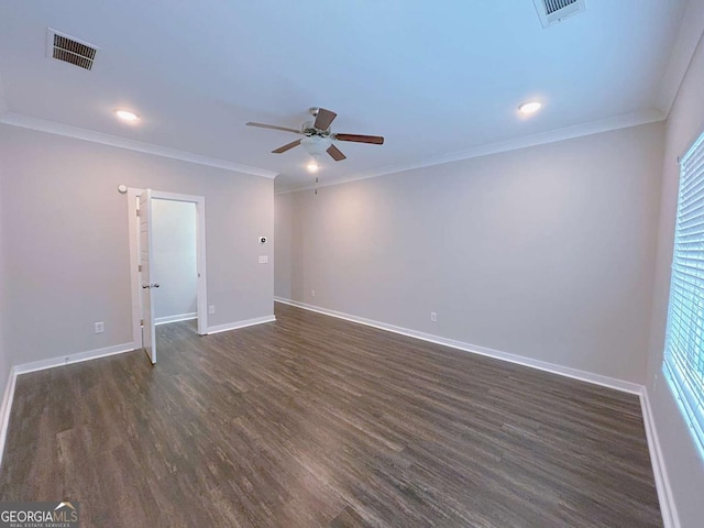 empty room with ceiling fan, plenty of natural light, dark hardwood / wood-style floors, and ornamental molding