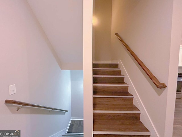 stairway with hardwood / wood-style floors