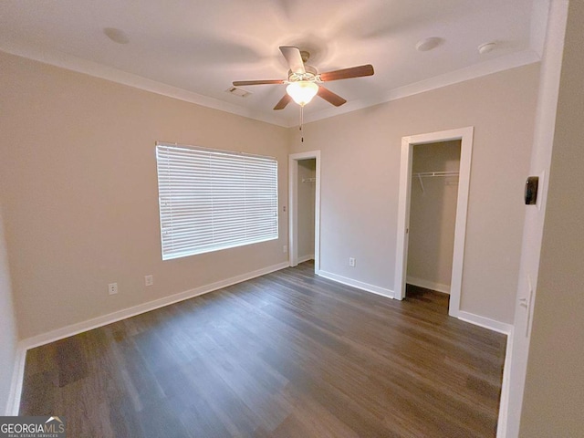 unfurnished bedroom featuring ornamental molding, a closet, ceiling fan, and dark wood-type flooring