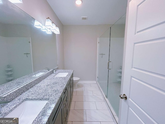 bathroom with tile patterned flooring, vanity, toilet, and walk in shower