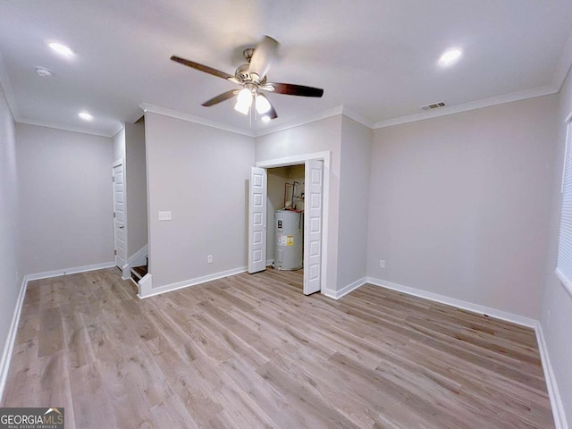 unfurnished bedroom with ceiling fan, electric water heater, ornamental molding, and light hardwood / wood-style flooring