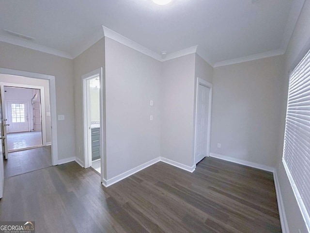 unfurnished room featuring dark hardwood / wood-style floors and ornamental molding