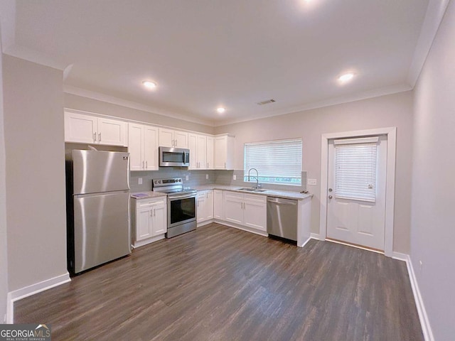 kitchen with white cabinets, stainless steel appliances, and dark wood-type flooring