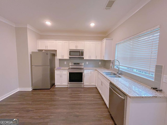 kitchen featuring white cabinets, stainless steel appliances, dark wood-type flooring, and sink