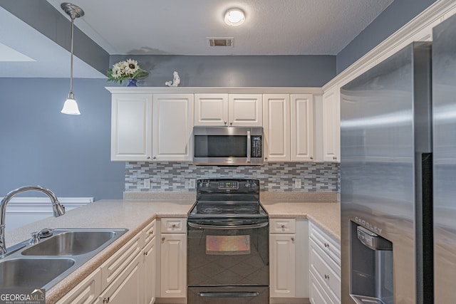 kitchen featuring white cabinets, sink, appliances with stainless steel finishes, and tasteful backsplash