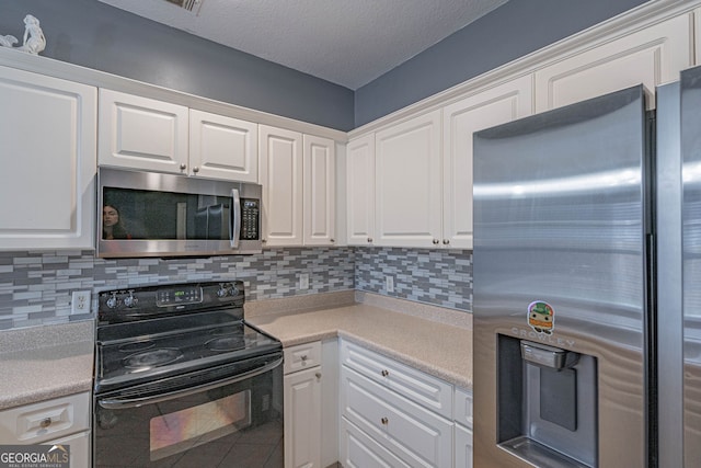 kitchen featuring white cabinets, backsplash, and stainless steel appliances