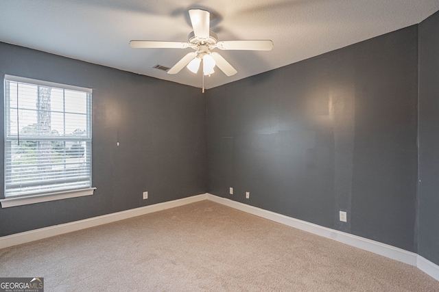 spare room featuring carpet and ceiling fan