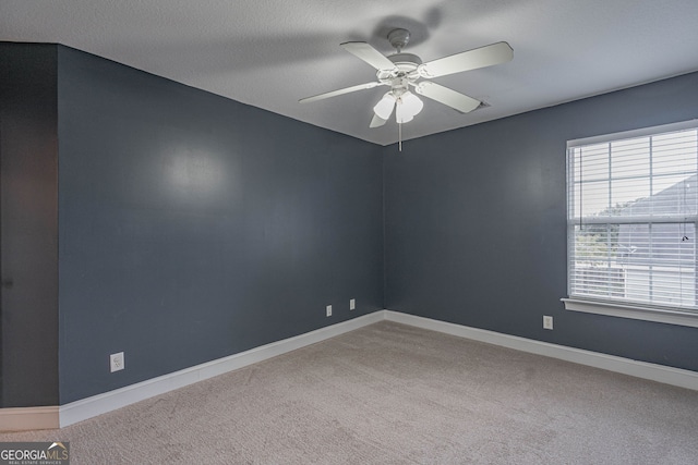 carpeted empty room with a textured ceiling and ceiling fan