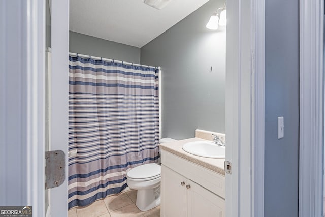 bathroom with toilet, vanity, tile patterned floors, and a shower with shower curtain