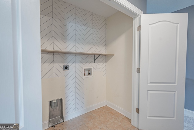 clothes washing area featuring hookup for an electric dryer, hookup for a washing machine, and light tile patterned flooring