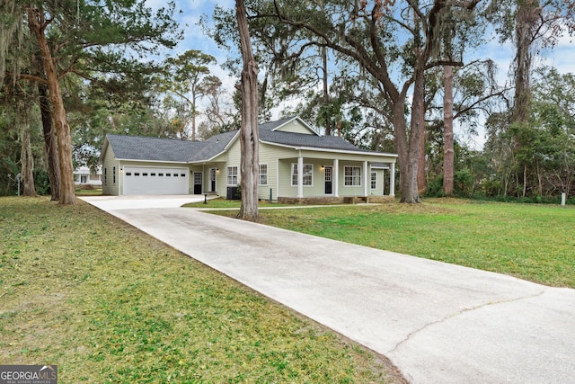 view of front of house with cooling unit, a front yard, and a garage