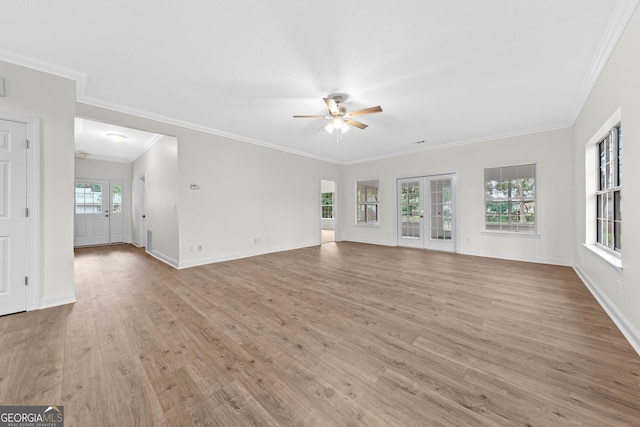 unfurnished living room featuring ceiling fan, ornamental molding, french doors, and light hardwood / wood-style flooring