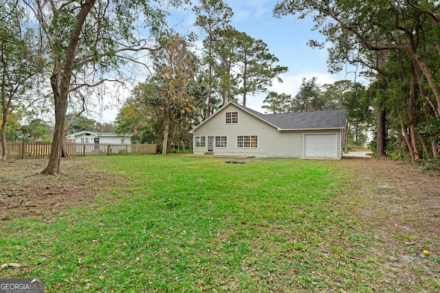 back of property featuring a lawn and a garage