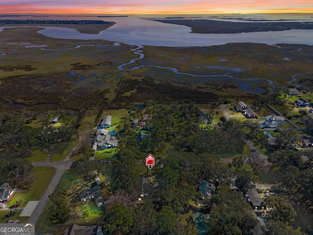 aerial view at dusk with a water view