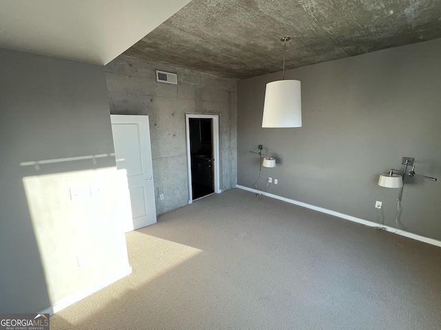 unfurnished room with carpet and visible vents