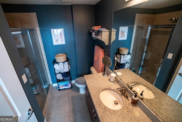 full bathroom featuring toilet, a stall shower, vanity, tile patterned flooring, and baseboards