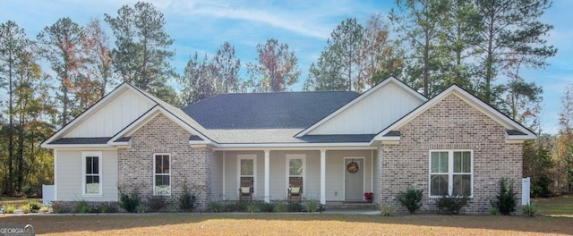 craftsman house with covered porch and a front lawn