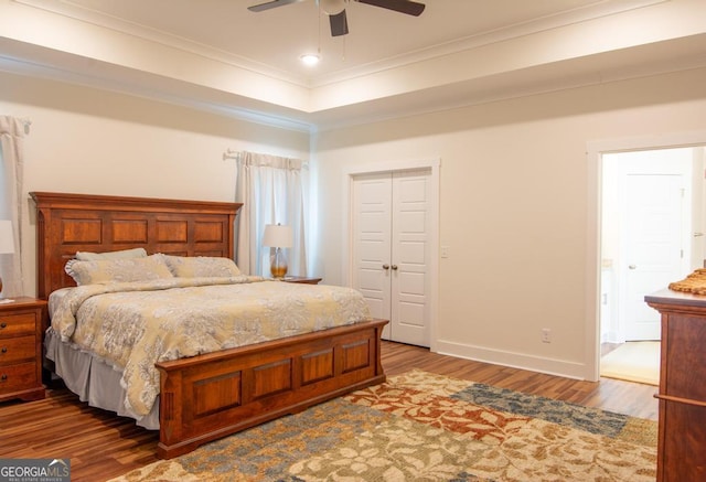 bedroom with ceiling fan, a closet, ornamental molding, and hardwood / wood-style flooring