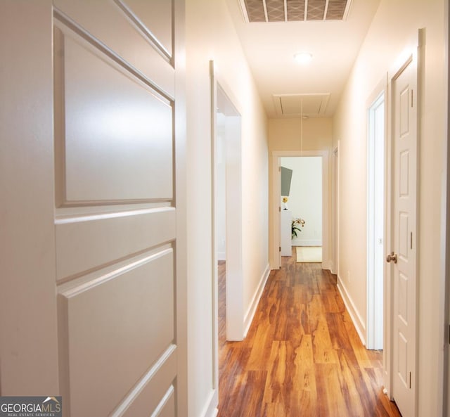 hall with hardwood / wood-style flooring