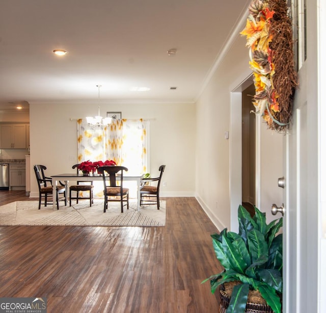 dining space featuring a chandelier, dark hardwood / wood-style floors, and ornamental molding