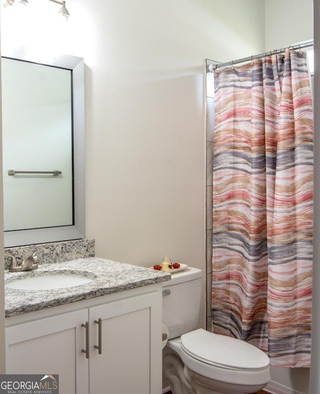 full bathroom with vanity, toilet, and shower / tub combo with curtain