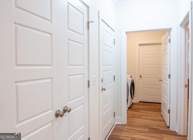 corridor featuring light hardwood / wood-style floors and independent washer and dryer