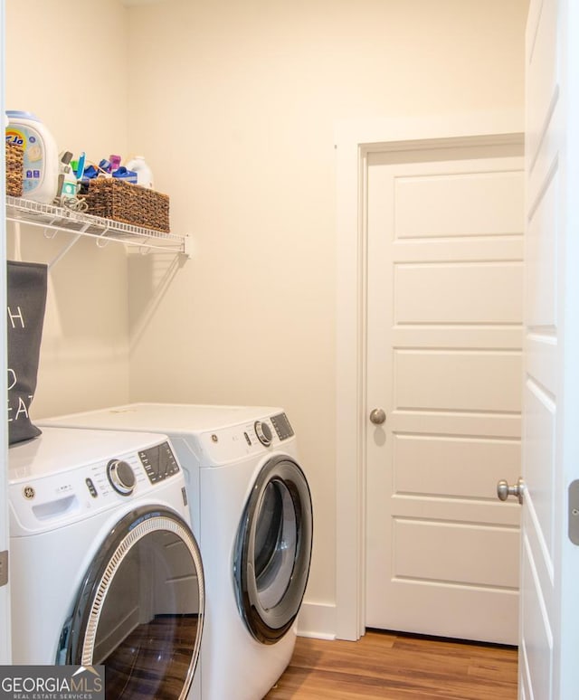 washroom featuring light hardwood / wood-style floors and independent washer and dryer