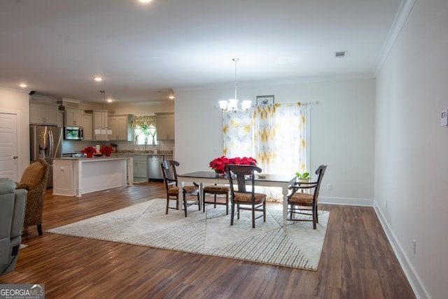 dining space featuring plenty of natural light, ornamental molding, and hardwood / wood-style flooring