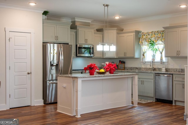 kitchen featuring hanging light fixtures, a kitchen island, stainless steel appliances, and dark hardwood / wood-style floors