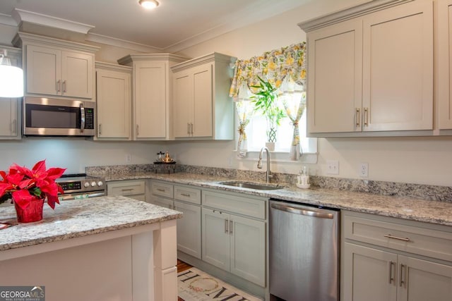 kitchen featuring light stone counters, crown molding, sink, and appliances with stainless steel finishes