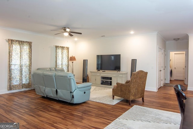 living room with ceiling fan, crown molding, wood-type flooring, and washer / dryer