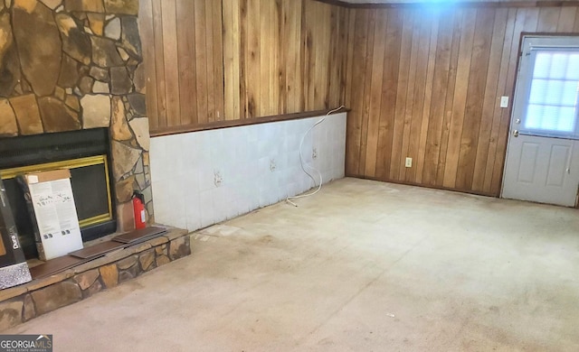 basement featuring wood walls and light carpet