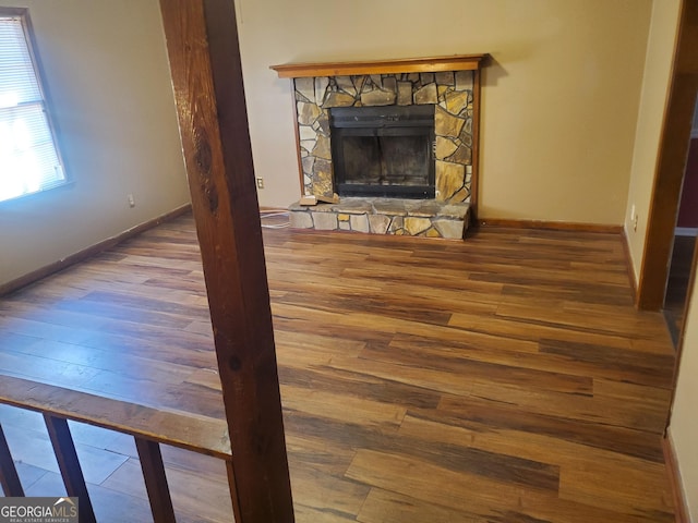 unfurnished living room featuring a fireplace and hardwood / wood-style flooring