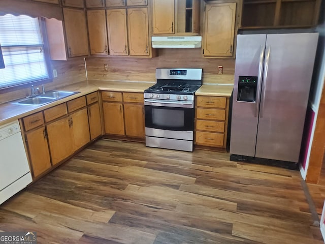 kitchen with appliances with stainless steel finishes, dark wood-type flooring, and sink