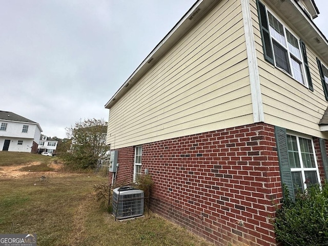 view of property exterior with a yard and cooling unit