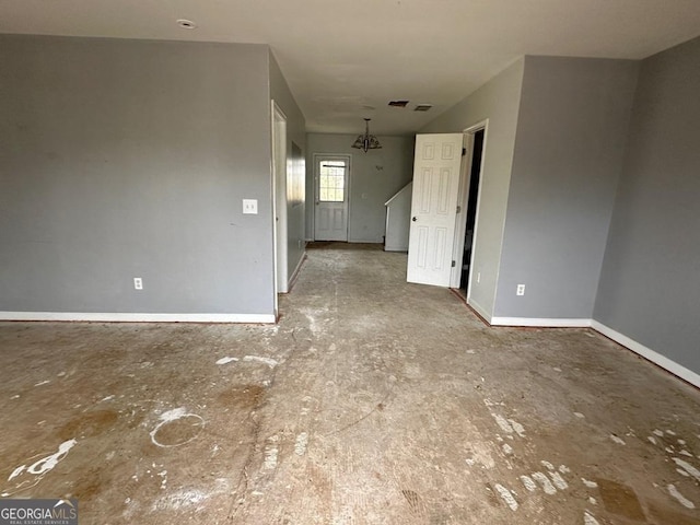 empty room featuring an inviting chandelier