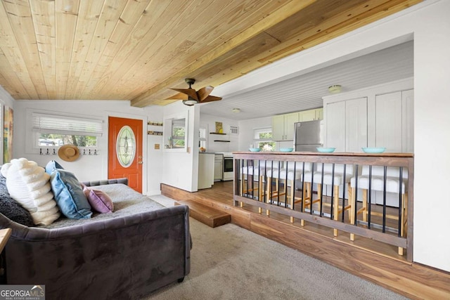 living room with light carpet, lofted ceiling with beams, ceiling fan, and wood ceiling